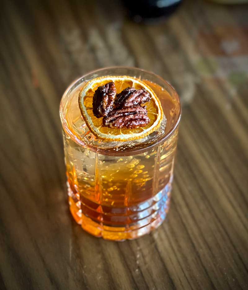 Maple Pecan Rye Cocktail on a wood table