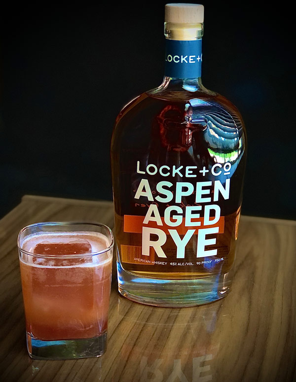 Not A Date Cocktail, bottle of Locke + Co. Aspen Aged Rye Whiskey on a wood table