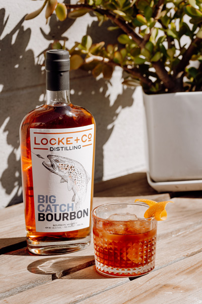 Locke + Co Distilling Big Catch Bourbon Bottle and The Revolver Cocktail